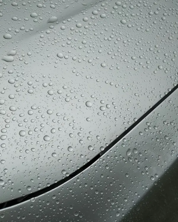 Water beading into tight droplets on silver paint