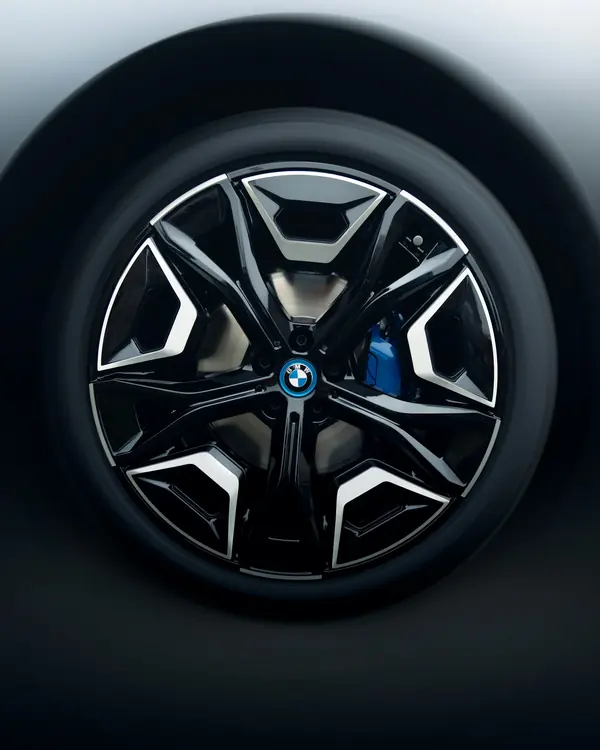 A clean two-tone alloy wheel with a blue brake caliper